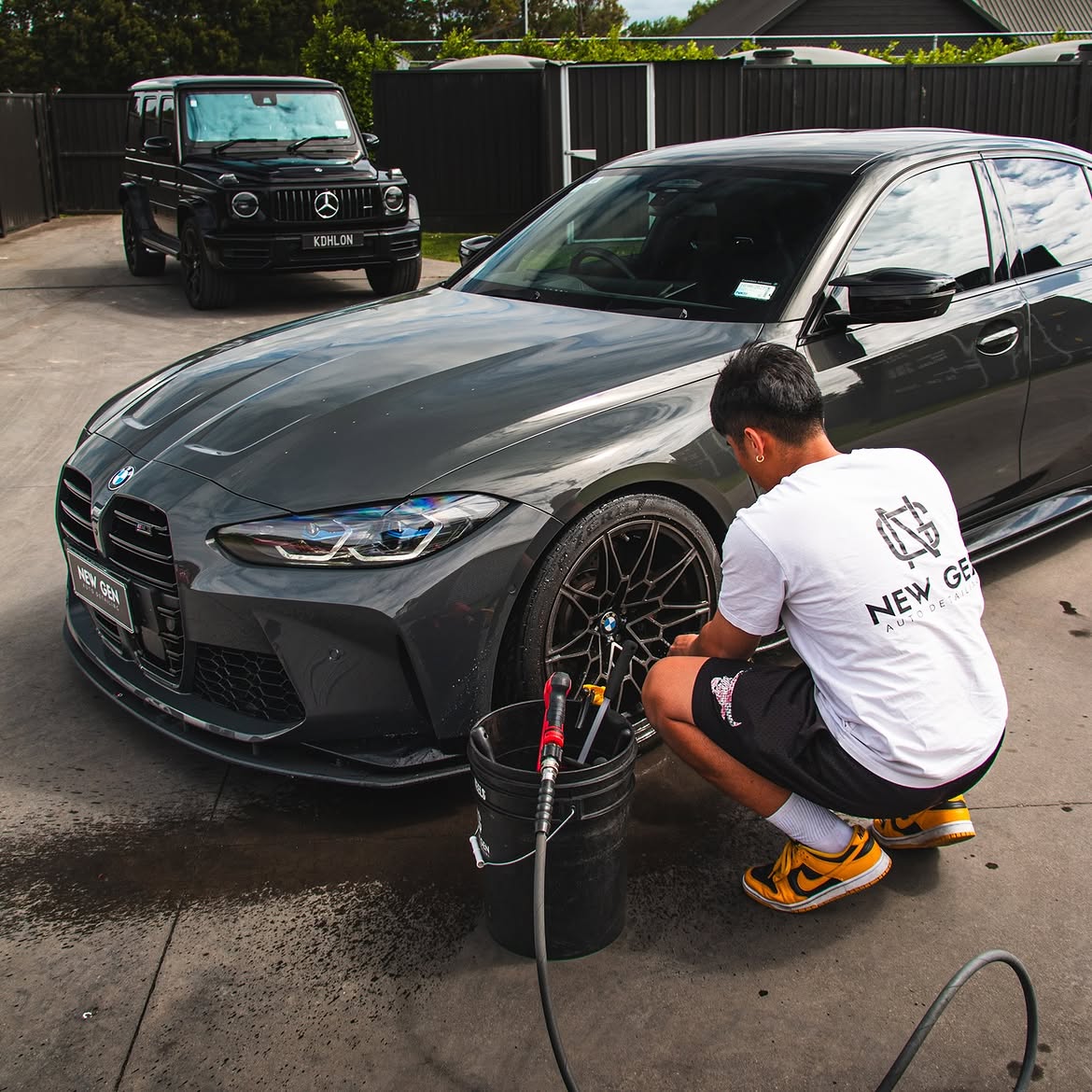 BMW M3 Competition — front three-quarter during wash
